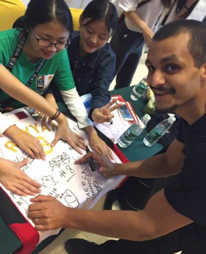 mizo amin signing a jersey at china