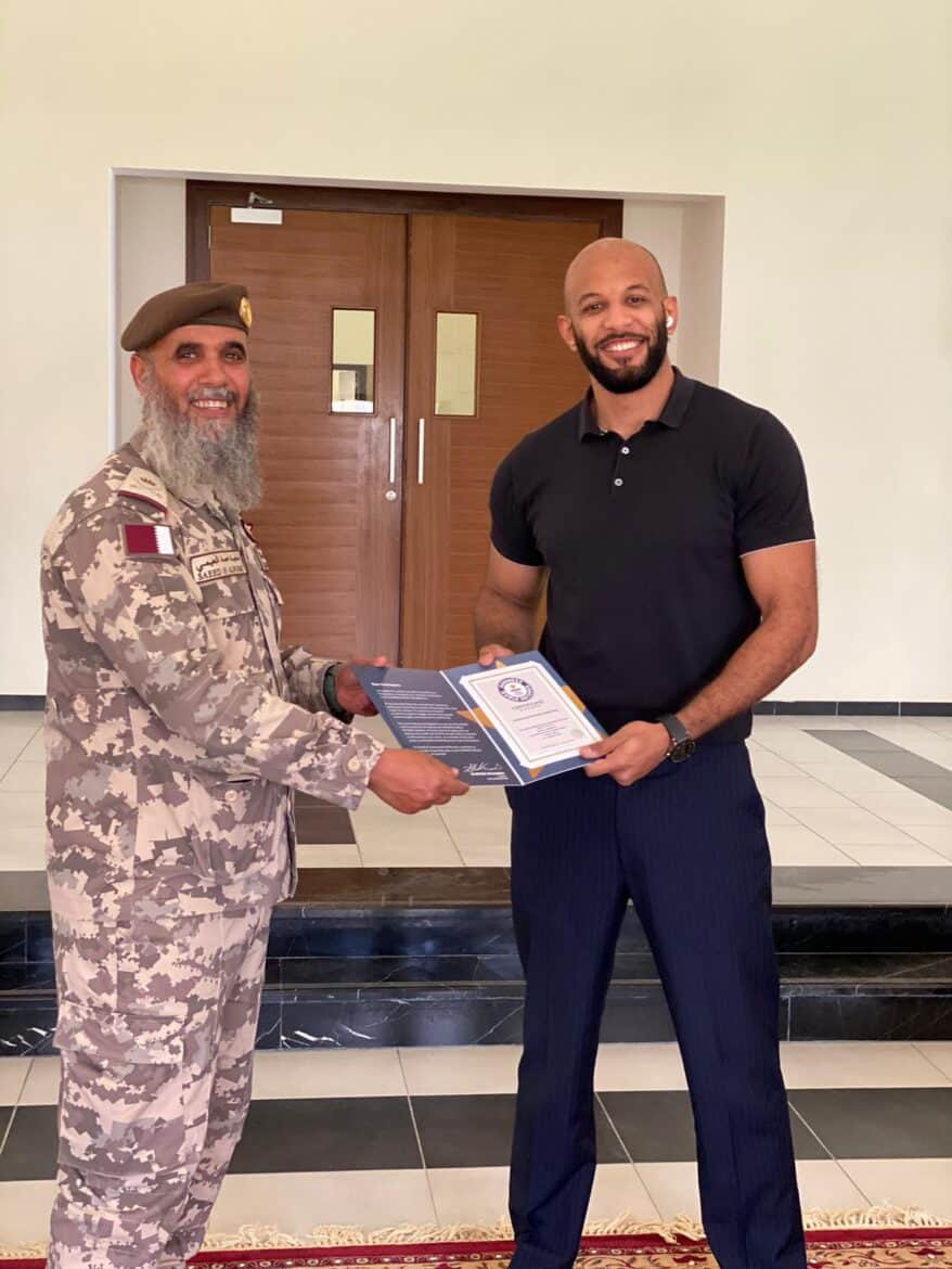 Atto Hamdy receiving his Guinness World Records participation certificate from the general Al-Noaimi